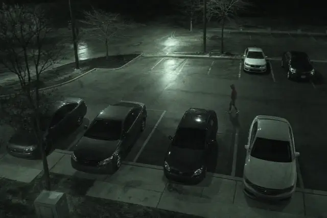 CCTV still from north parking lot showing person in red hoodie during active investigation review